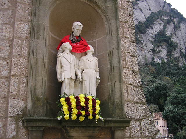 фото статуи мужчины с двумя учениками в монастыре Монтсеррат в Каталонии, Испания