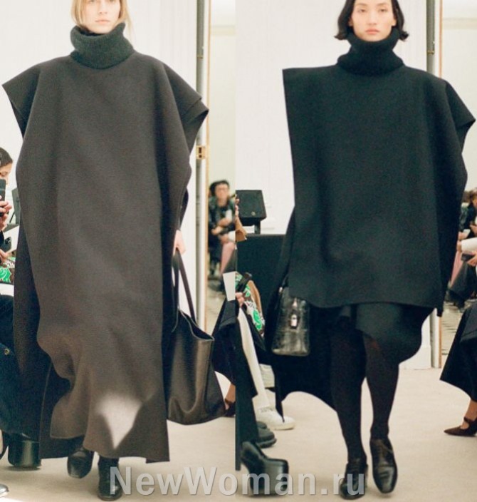 женское модное кашемировое темное двухслойное пальто 2024 года - пончо-табард, надетое поверх свитера с высоким воротом.
