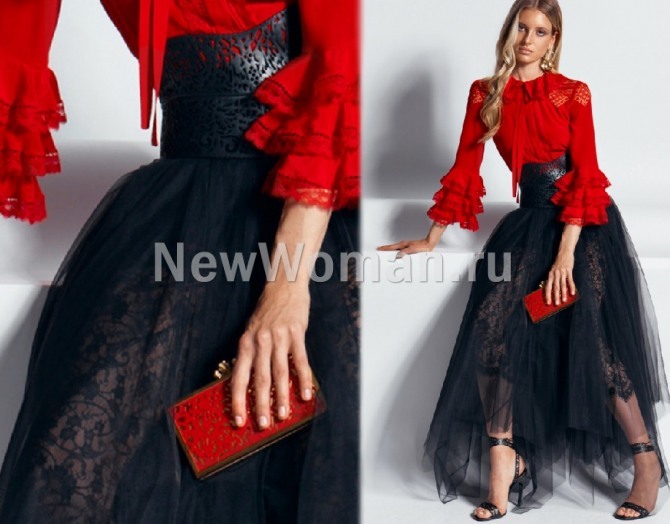 пышная черная вечерняя юбка с асимметричным подолом из двух слоев - кружевного и сетчатого, имеет ажурный кожаный пояс, надета поверх красной блузки в романтическом стиле - модные тренды юбок лето 2020 года с мировых показов моды