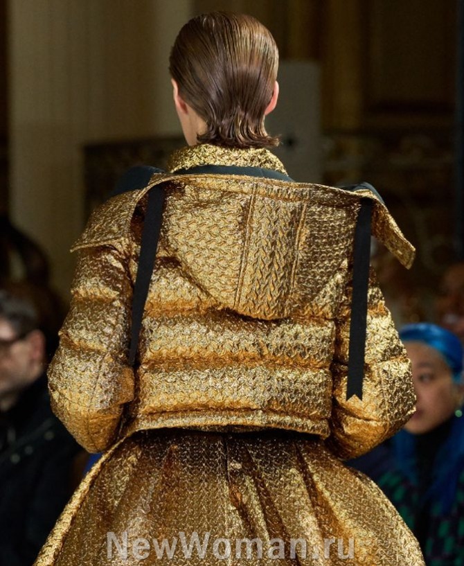 короткая женская куртка с капюшоном из металлизированной ткани золотого цвета, имитирующей парчу.